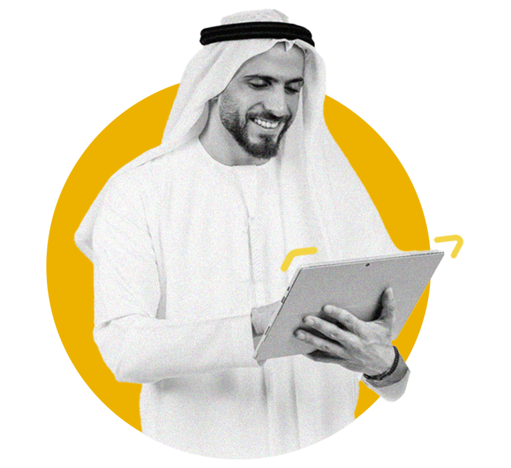 A smiling man wearing a kandura and ghutra looks down at a tablet he is holding, set against a bright yellow circle, showcasing professional engagement with Gatehills' services.